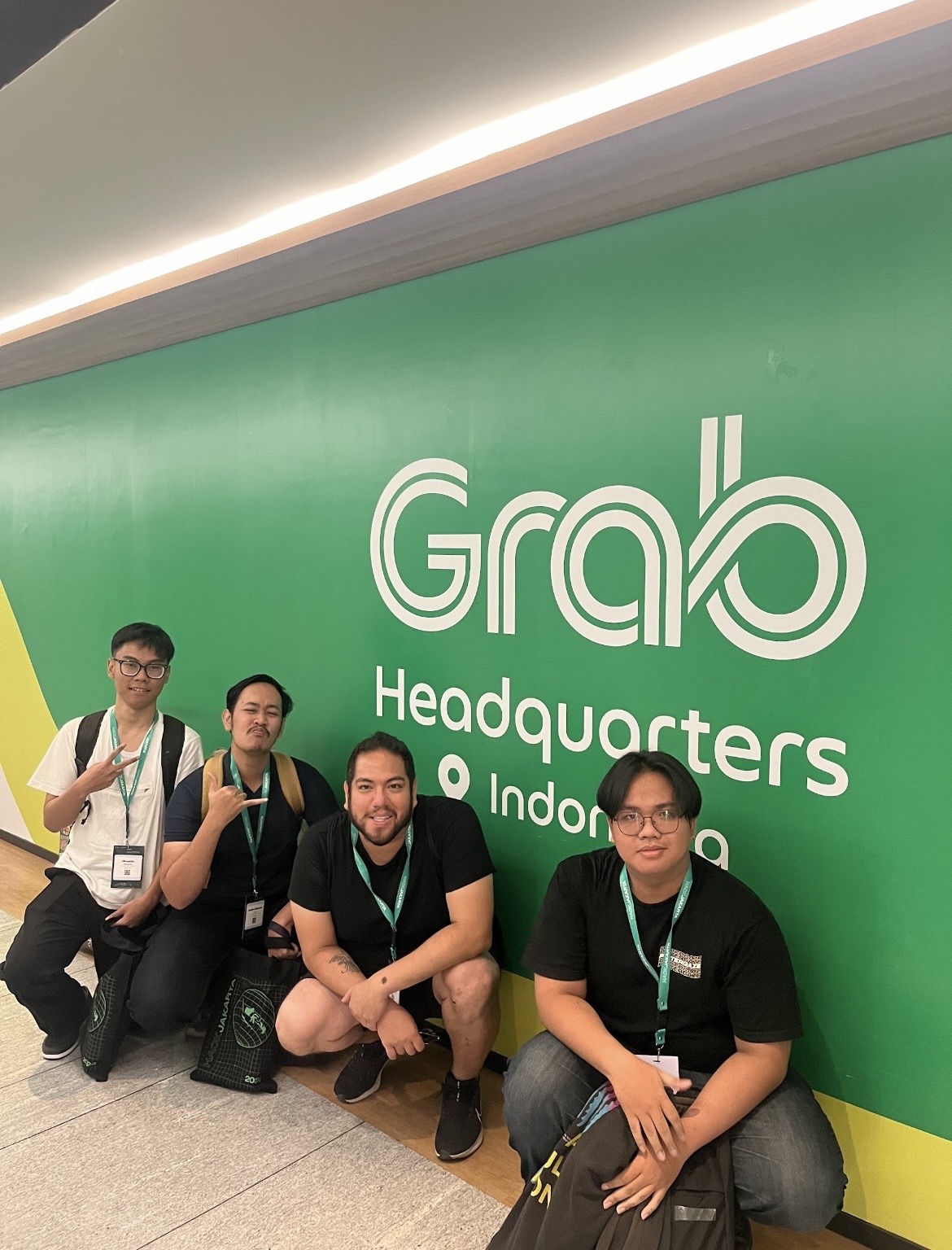 Christian and the Binary Bros team posing at Grab Headquarters in Jakarta, Indonesia during a global technology mentorship and hackathon collaboration.
